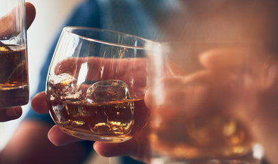 people holding glasses filled with alcohol 