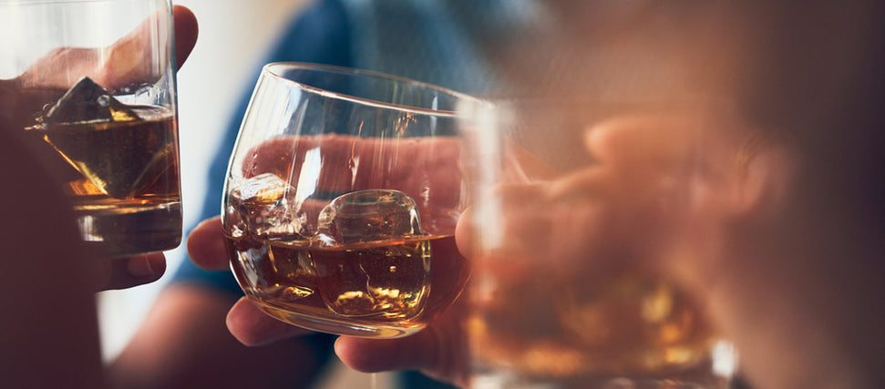 people holding glasses filled with alcohol 