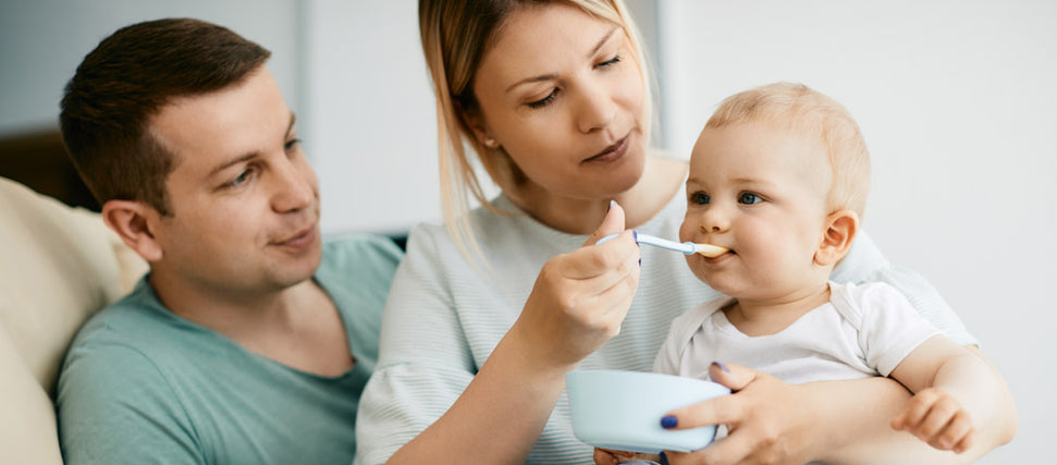 mom and dad feeding baby