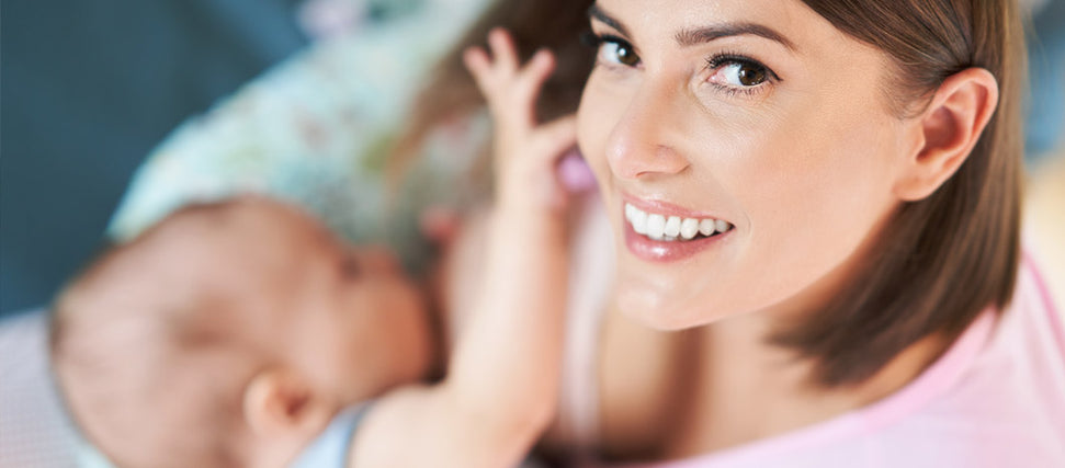 baby latching on mother's breast