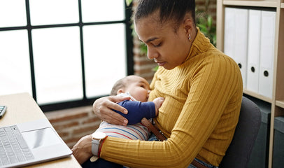 mom breastfeeding baby at work