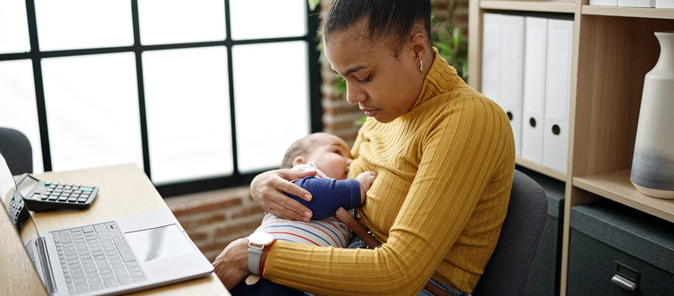 mom breastfeeding baby at work