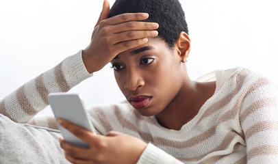 concerned woman looking at phone for answers