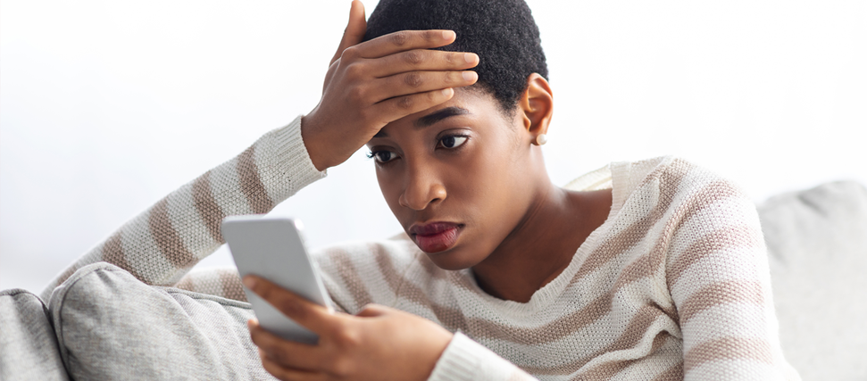 concerned woman looking at phone for answers