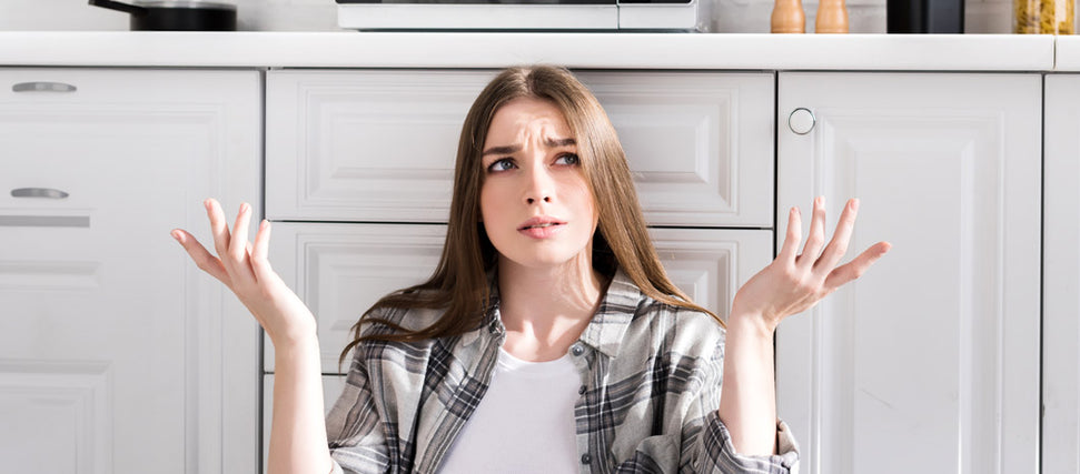 confused woman with arms raised