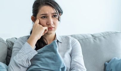 frustrated woman sitting on couch