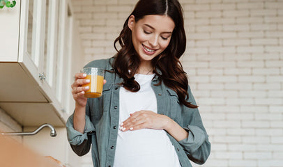 happy pregnant woman looking at belly