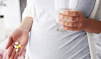 woman holding handful of nursing supplements 