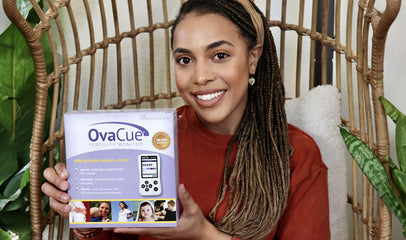 woman holding OvaCue fertility monitor