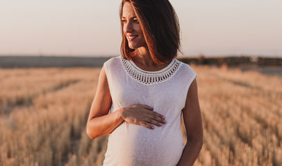 pregnant woman walking in the fields