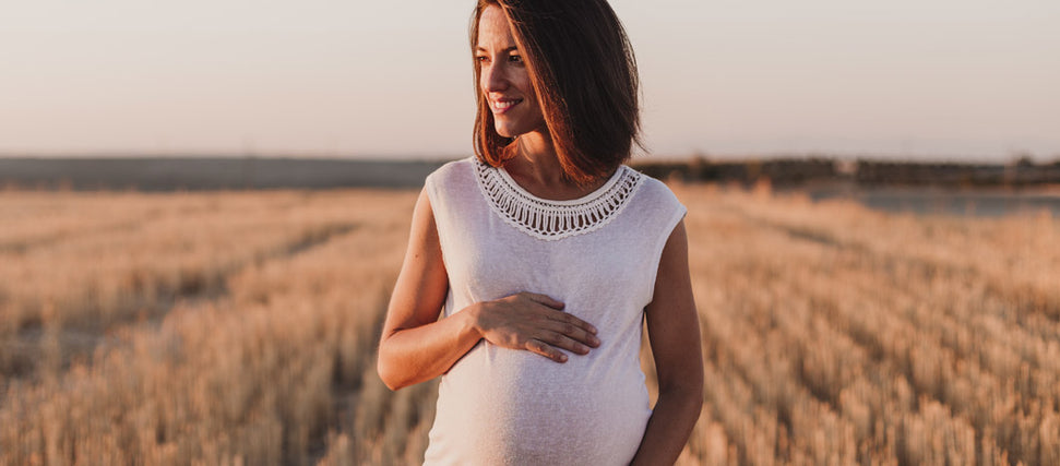 pregnant woman walking in the fields