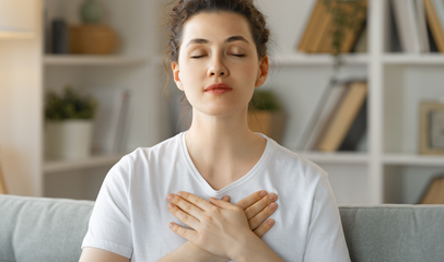 woman holding her chest due to breast sensitivity