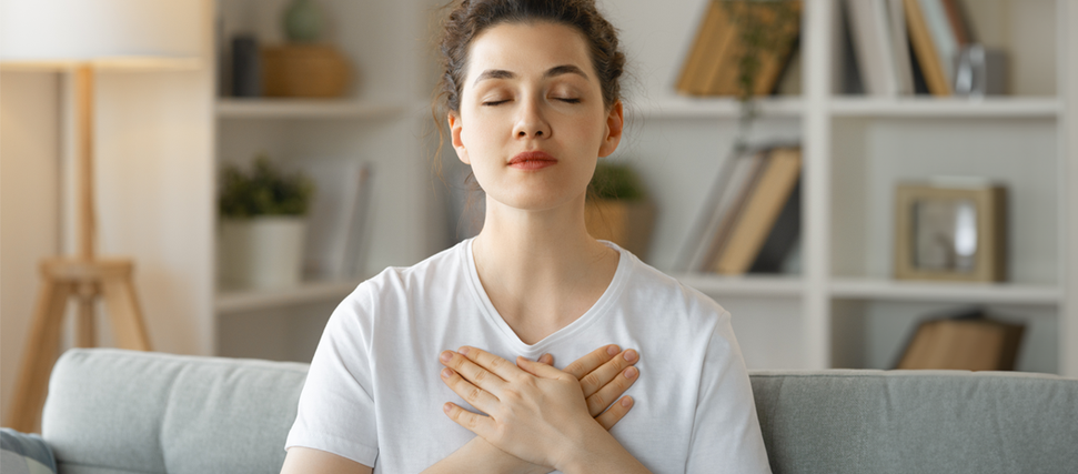 woman holding her chest due to breast sensitivity