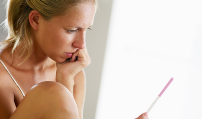 woman holding pregnancy test