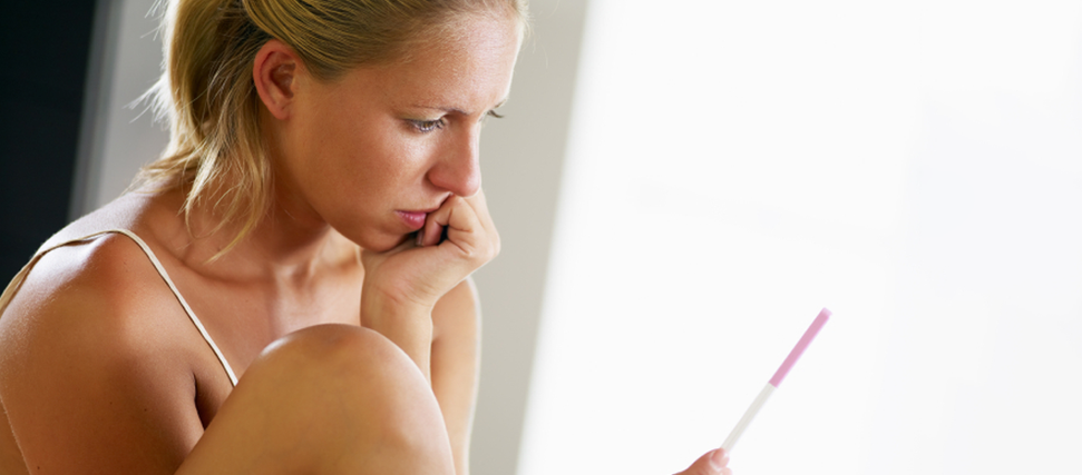 woman holding pregnancy test