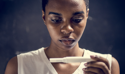 woman looking at pregnancy test