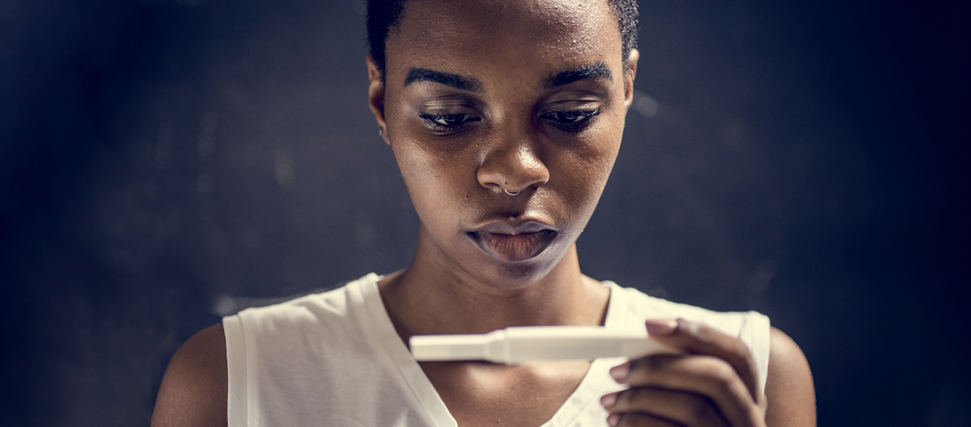 woman looking at pregnancy test