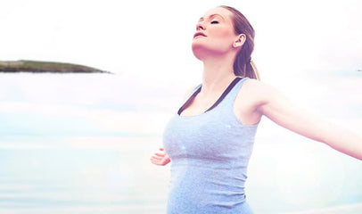 woman stretching her arms by the water